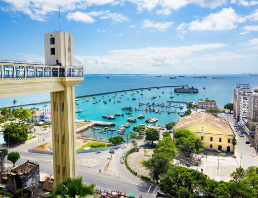 foto de cartão postal de Salvador, com a praia cheia de barcos e um prédio mirante.